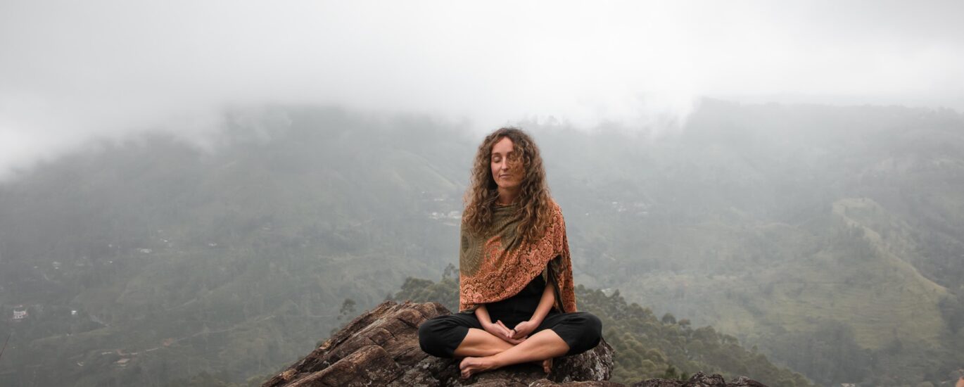 Woman breathwork on a mountain