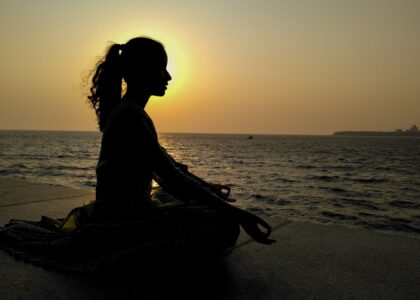 Woman meditating by the ocean
